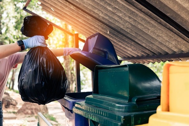 Man Throwing Rubbish on Garbage